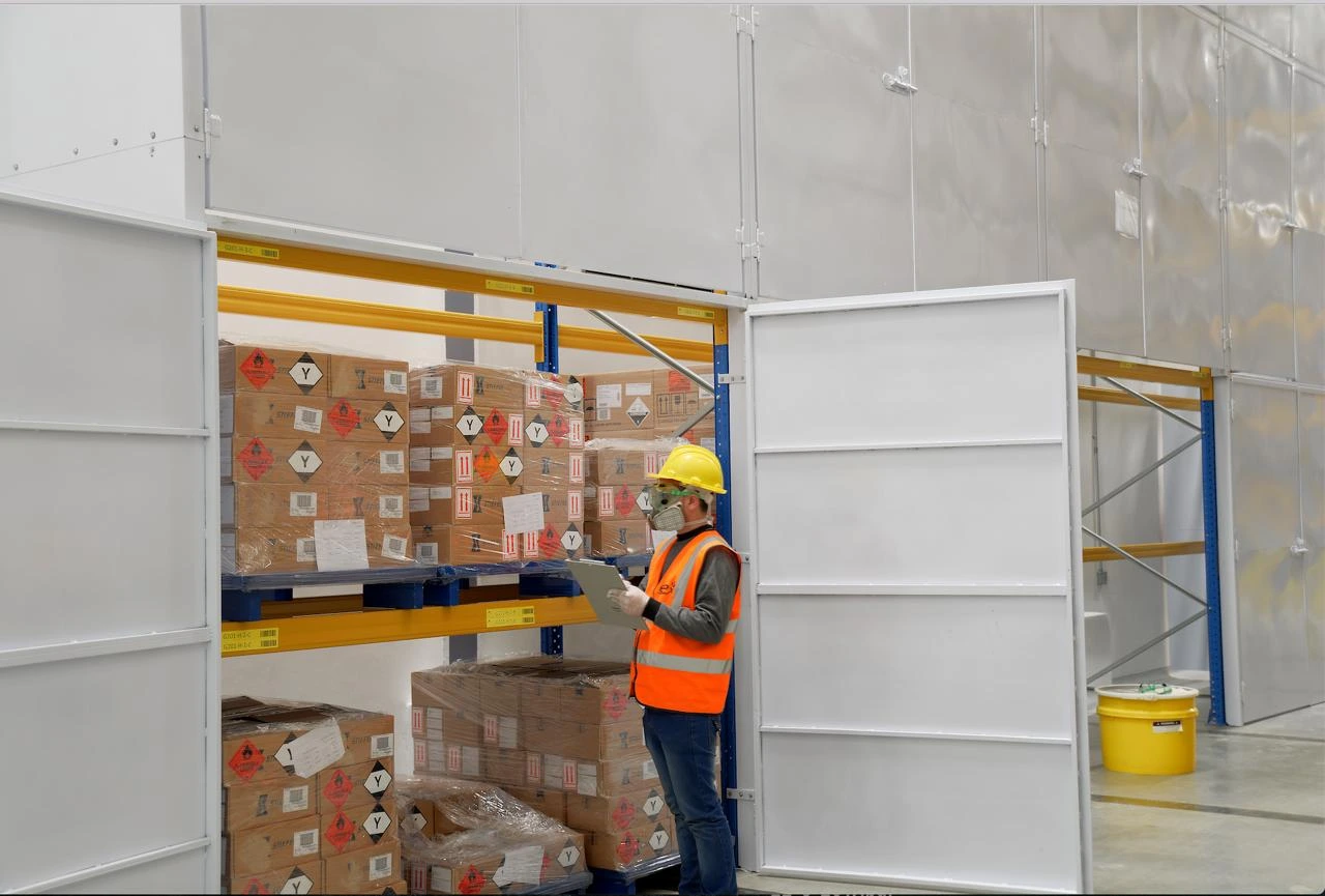 An EPx operator checking labelled cartons in an access-controlled clinical trial storage zone